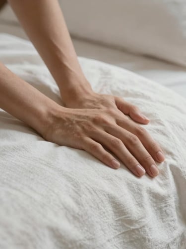 Macro detail shot of hands carefully smoothing crisp linen sheets on a beautifully styled bed, soft natural morning light, editorial aesthetic.