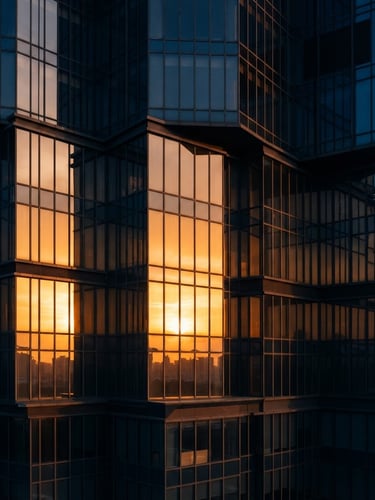 Architectural detail of a modern luxury skyscraper facade in Gurgaon, warm golden-hour sunlight reflecting off floor-to-ceiling glass panels, sharp angles, 35mm lens.