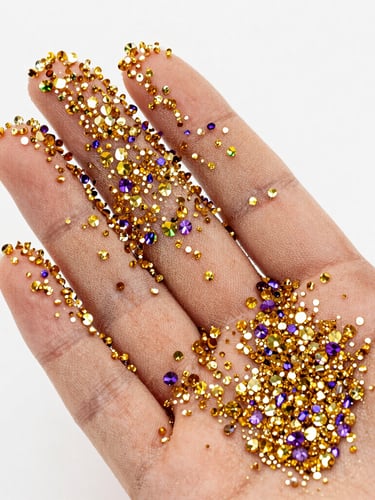 Macro studio shot of sparkling gold and violet crystals hand-applied to sheer nude mesh, high-key bright lighting, extreme detail