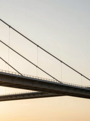 Wide shot of a contemporary architectural bridge suspended over a clean void, pure steel lines illuminated by a warm golden sunset.