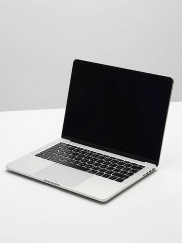 Modern silver laptop open on a clean desk, bright high-key studio lighting, isolated on light gray backdrop, crisp sharp focus