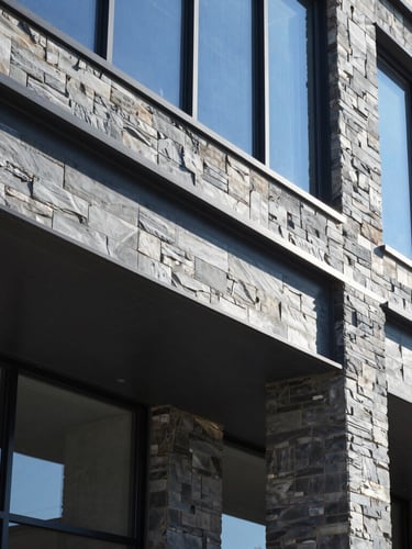 Sharp architectural photography of a modern Ontario commercial building frame under bright natural daylight, clean steel beams, cool slate tones, 35mm