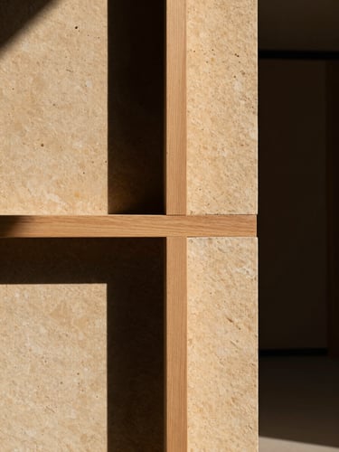 Abstract close-up of raw sandstone blocks and teak wood joinery, dramatic shadows, warm tones, architectural studio setting