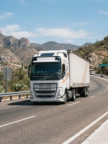 Wide-angle highway shot of a modern heavy-duty cargo truck driving in bright daylight on a Mexican highway, clean corporate tones with subtle orange accents, sharp focus, 35mm