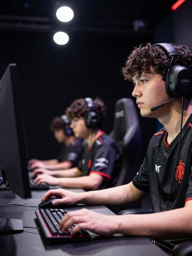 Competitive esports player at a lit tournament stage, focused gaze directed at monitor, hands on mouse and keyboard, high-contrast arena overhead lighting, dark background