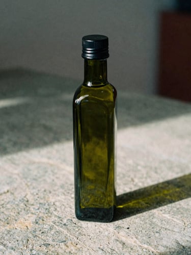 A beautiful dark green glass olive oil bottle on a rough stone surface, soft natural light casting long shadows, cozy Scandinavian aesthetic, 35mm film.