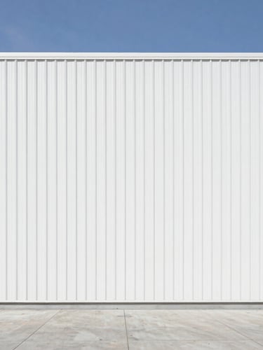 Sharp architectural photograph of a pristine, modern logistics terminal under bright natural daylight, clean high-contrast tones, straight-on medium shot, 35mm lens