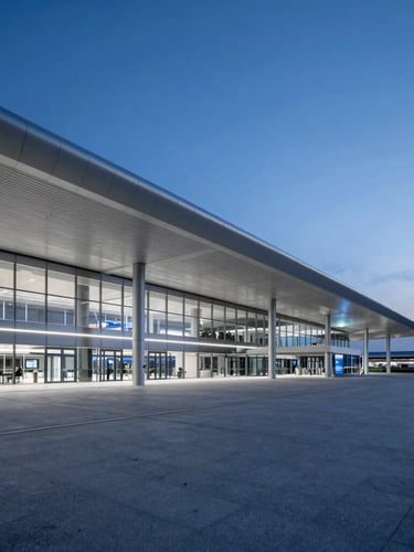 Sleek wide-angle conceptual shot of modern airport terminal architecture at twilight, glowing blue and silver tones, clean lines, negative space