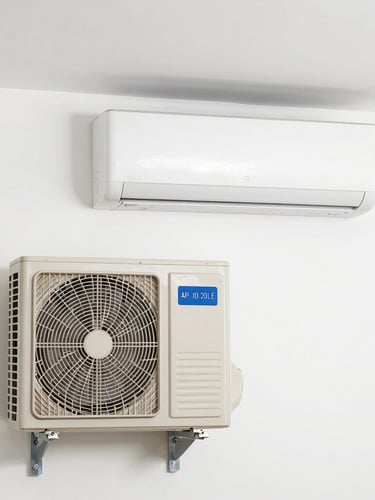 A clean indoor wall air-conditioning unit paired with an outdoor compressor unit, neatly installed on a clean white wall, bright realistic utility lighting, straight-on medium shot, no people.