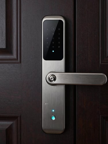 Close-up of a premium brushed-metal smart lock on a dark wood door, subtle cyan indicator light glowing, sharp focus, architectural background