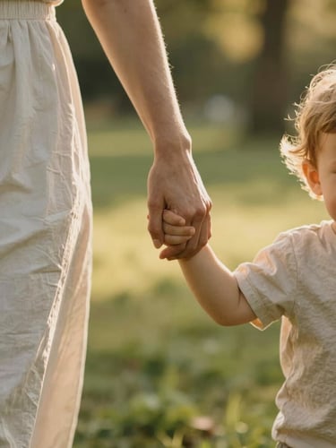 Close-up detail of a mother holding her toddler's hand while walking through a sunlit park, soft golden hour light, warm emotional connection, shallow depth of field.