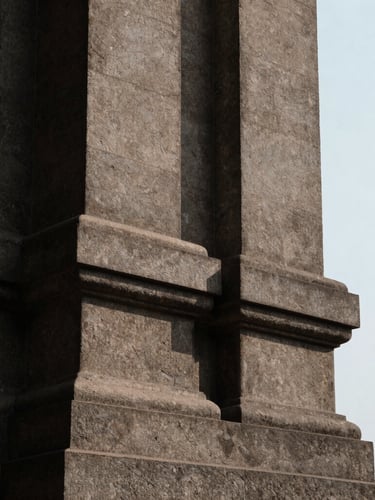 A close-up, high-contrast architectural crop of a brutalist stone column in Mumbai, sharp dramatic shadows, overcast natural light