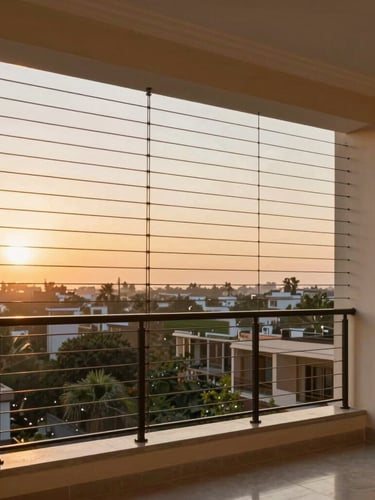 Elegant residential balcony in Hyderabad with high-tensile invisible safety grills blending into the warm sunset skyline, 35mm