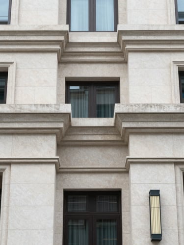 Symmetrical architectural detail of a premium residential facade with clean stone lines under soft overcast daylight