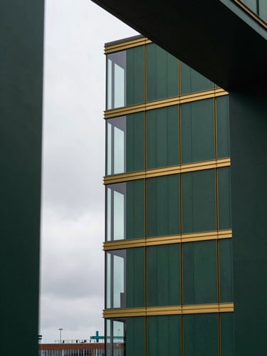 Low-key architectural detail of the modern Rotterdam port, overcast European daylight, deep forest green tones, 35mm lens framing