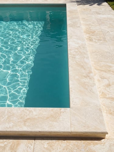 Straight-on architectural elevation of a luxury villa pool edge in France, where turquoise water meets perfectly aligned light stone coping, bright natural Mediterranean daylight, sharp clean shadows, minimalist and technical composition.