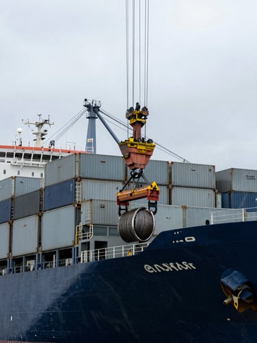 Overcast day at Callao port, a crane lifting heavy steel wire ropes and technical deck stores onto a large container ship, cool metallic tones, industrial maritime photography