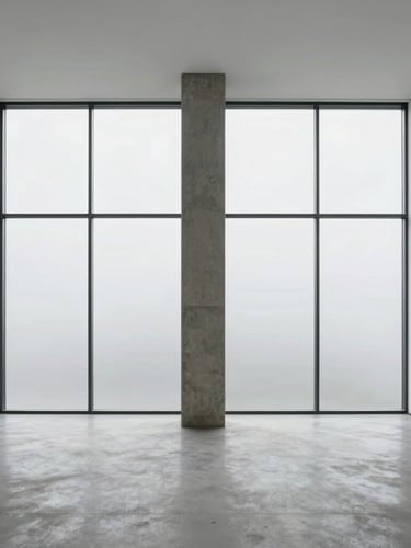 Minimalist interior with a single concrete pillar and diffused overcast light from a massive window, stark white gallery walls.