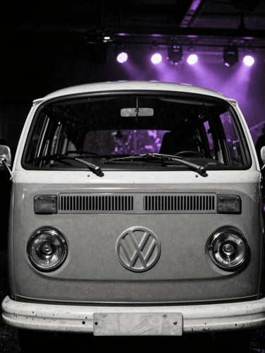 Gritty high-contrast black and white photo of a vintage Volkswagen Kombi serving craft beer, backlit by purple neon strobe lights, dark underground concert vibe.