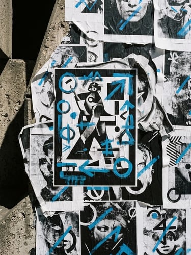 High-contrast 35mm film photograph of a wild-posting campaign mockup on a brutalist concrete wall, harsh dramatic shadows, bright midday sun, electric blue accents.