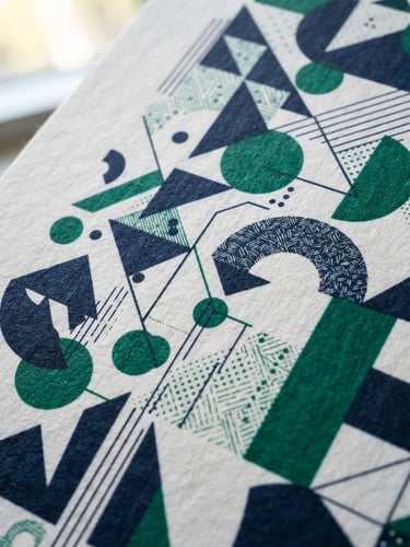 Macro close-up of premium textured paper with printed direct mail graphics, sharp focus, natural office window light, deep navy and emerald green details, 35mm