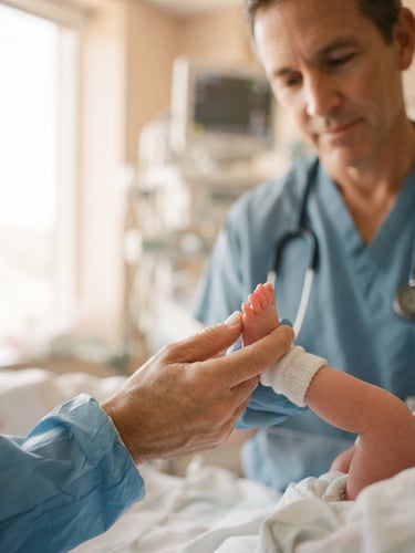 A specialized neonatologist gently holding a newborn's tiny foot under soft, warm window light, shallow depth of field, 35mm photography