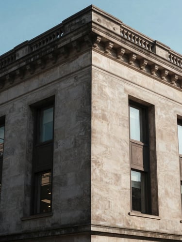 Wide architectural angle of a classic stone financial institution facade with deep geometric shadows, soft morning light