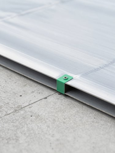 Macro shot of a high-performance waterproofing membrane joint, perfectly welded, clean concrete background, architectural precision, overcast daylight, 35mm