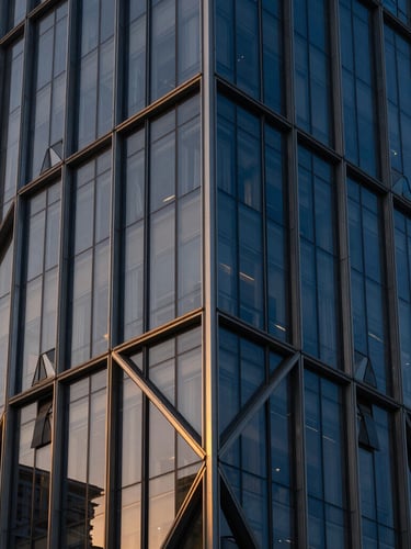 Abstract architectural close-up of modern geometric glass facade in Shenzhen, sharp angles, dramatic golden hour lighting, Hasselblad medium format