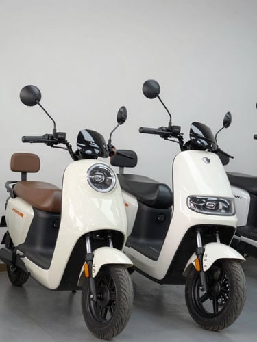 Three-quarter profile of an electric cargo rickshaw and a sleek electric scooter parked side-by-side in a bright showroom, neutral background, clean daylight.