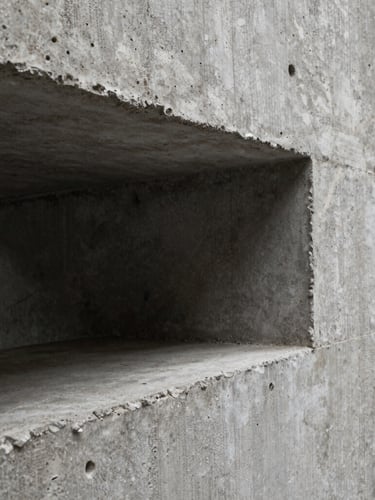 Macro crop of architectural raw concrete texture, hard studio key light, deep shadows, brutalist form.