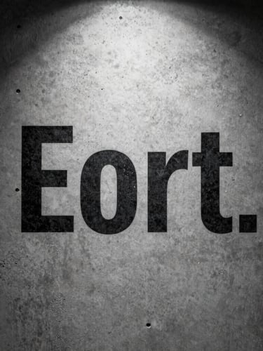 Extreme macro crop of stark black typography printed on heavy textured concrete, hard studio key light, deep shadows, off-center composition.