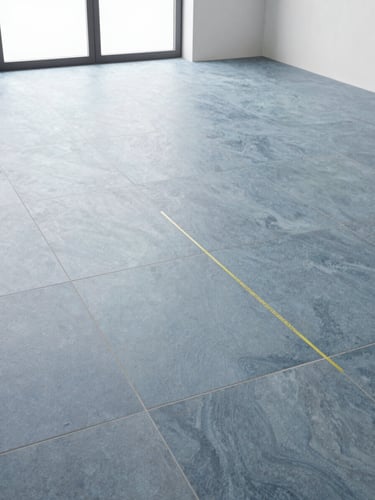 Low-angle shot of perfectly aligned large-format porcelain tiles in a bright modern kitchen, laser level line visible, cool slate blue tones, 35mm
