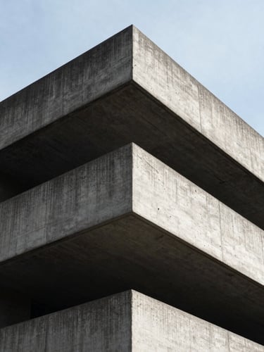 Low-angle heroic shot of a brutalist concrete structure in London, hard directional daylight, deep shadows, raw stone textures, 35mm lens.