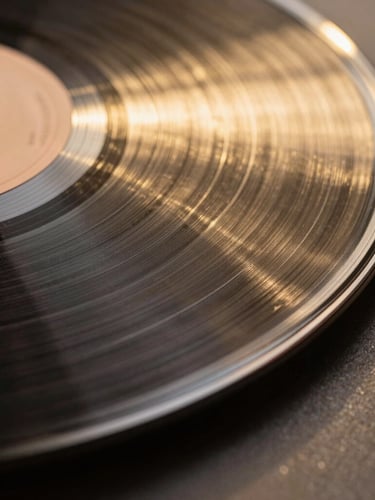Macro shot of vinyl grooves under a warm gold spotlight, deep shadows, high-contrast, sharp geometric lines