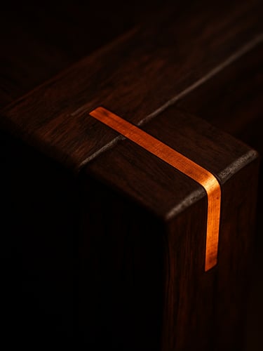 Macro detail shot of a hand-carved dark walnut wood joint with integrated glowing copper inlay, warm low-key dramatic lighting, shallow depth of field, 50mm lens