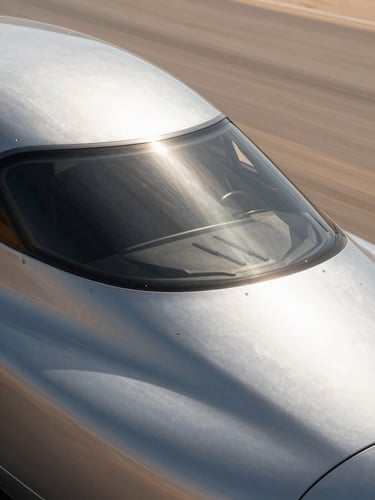 Macro engineering close-up of a high-speed transport vehicle roof under intense high-contrast desert sunlight, showing precise platinum-toned polymer shield integration, deep shadows.