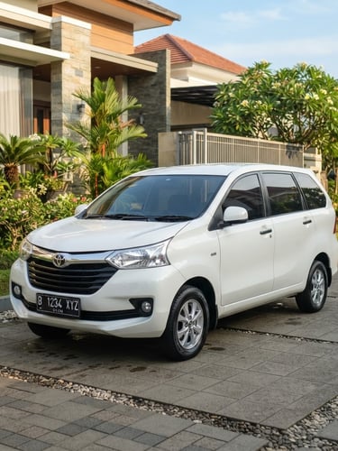 Bright outdoor automotive photography of a clean white Toyota Avanza parked in a modern Indonesian residential driveway, warm morning sunlight, sharp focus.