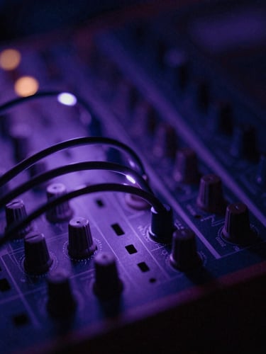 Extreme shallow depth of field shot of modular synth patch cables glowing under soft back-lit violet light leaks, dark atmosphere.