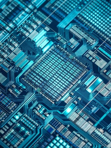Extreme macro close-up of a micro-display chip reflecting cool-toned cyan strobe light in a cleanroom, showing sub-micron circuit alignments