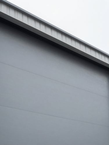 Low-angle architectural shot of a massive industrial sliding door profile, clean overcast daylight, metallic gray steel textures, sharp focus, 35mm lens