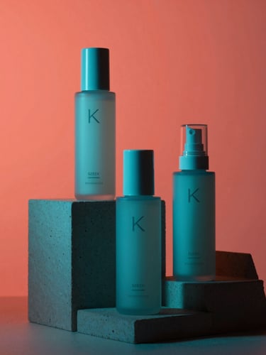 Sleek K-beauty bottles placed on geometric concrete pedestals against a vibrant coral background, dramatic studio lighting, sharp focus, 35mm
