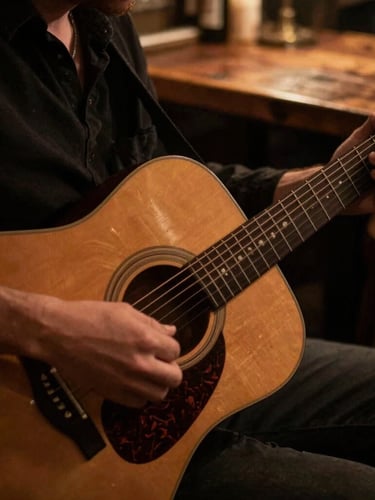 Close-up of hands playing an acoustic guitar under warm stage lighting, rustic wooden table in the background, shallow depth of field, 35mm.