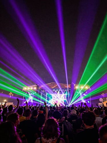 Low-angle wide shot of a massive music festival crowd under vibrant electric purple and acid green lasers, cinematic grain, 35mm