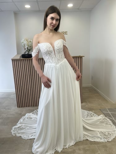 a woman in a white dress standing in a room