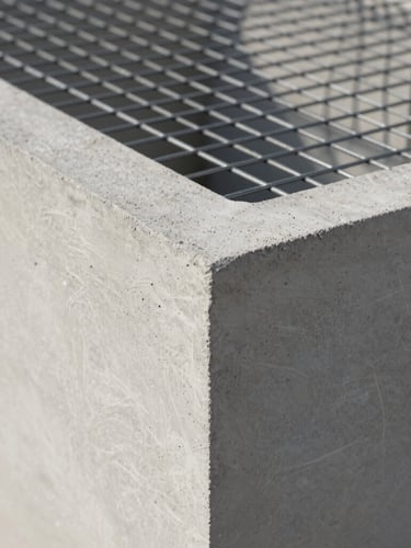 Close-up of a raw EPS monolithic structural panel integrated with high-strength microconcrete, showing the steel mesh grid and clean geometric texture under sharp natural light