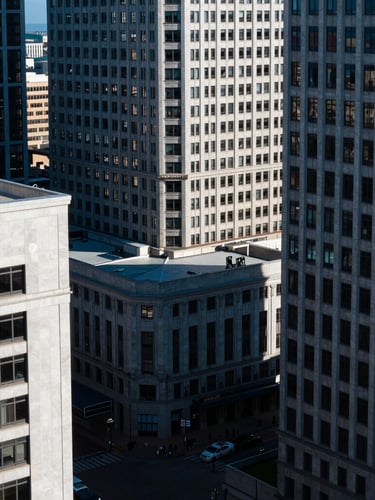 High-altitude urban geometry of downtown St. Petersburg, crisp daylight, sharp shadows, deep blue tones, 35mm lens.