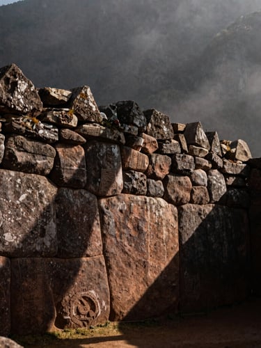 Close-up of ancient Inca stone masonry at Ollantaytambo, soft morning mist, deep shadows, earthy tones, moody documentary style.