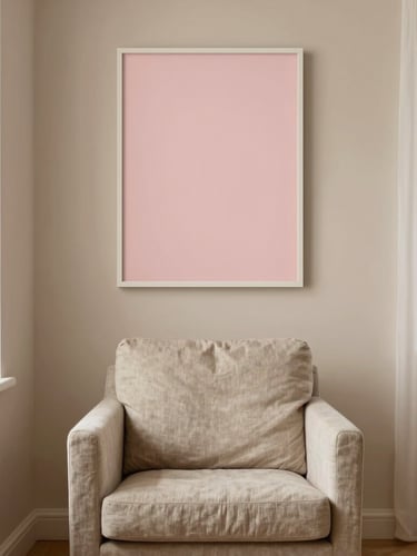 Straight-on architectural photo of a cozy Scandinavian living room corner, a soft linen armchair in oatmeal, a blank canvas framed on a warm beige wall, diffused natural daylight, 35mm