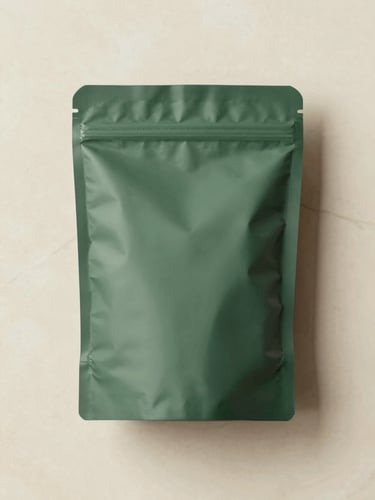 Clean editorial overhead flat-lay of a discreetly sealed forest green package on a warm cream marble surface, soft natural daylight, 35mm